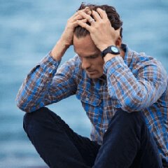 Person taking a quiet moment near water